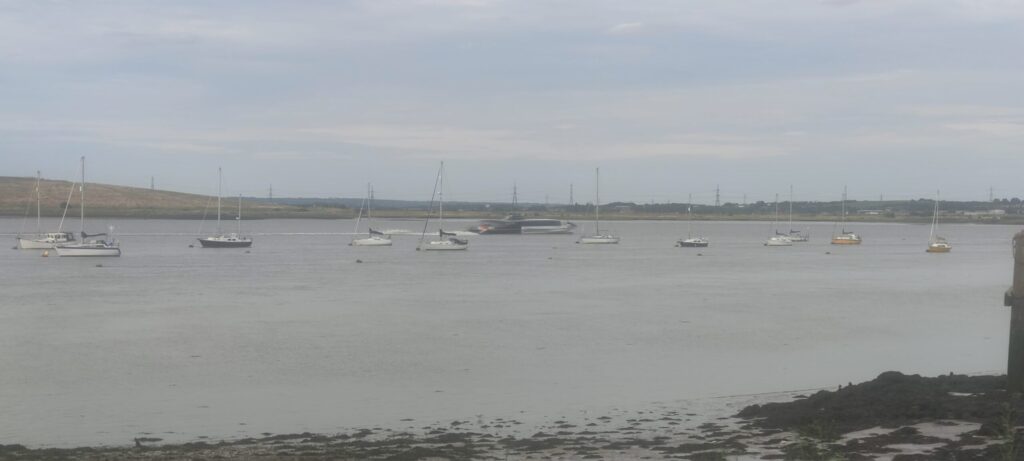 Thames Clipper seen passin the moorings at Erith Yacht Club as it heads down the Thames river.